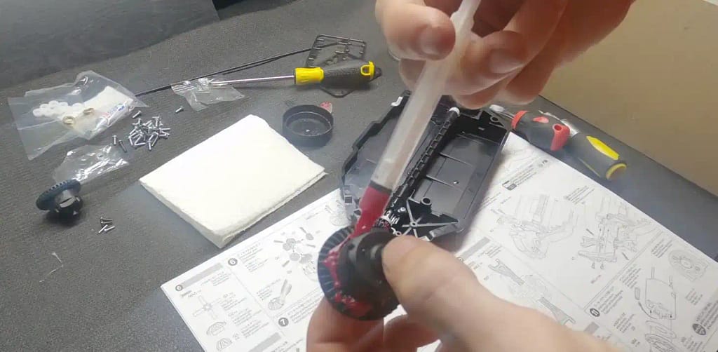 Applying grease to the TT-02 ring gears with a syringe