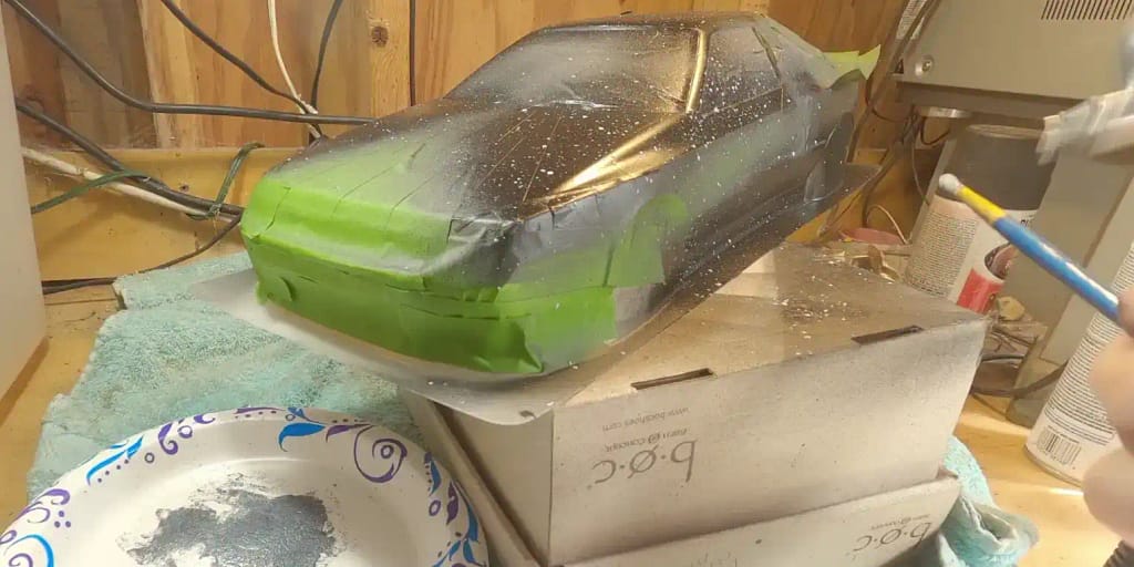 Tamiya Celica ST165 body masked with green FrogTape for custom splatter paint effect