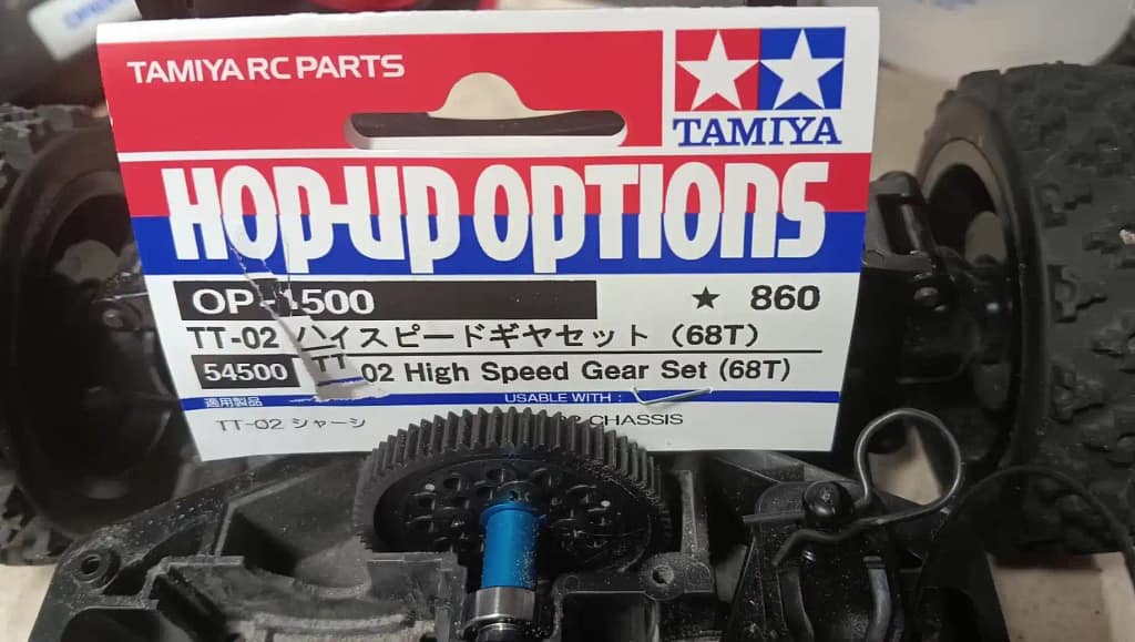 Tamiya TT-02 68T High Speed Gear Set shown installed in the car with the packaging behind it
