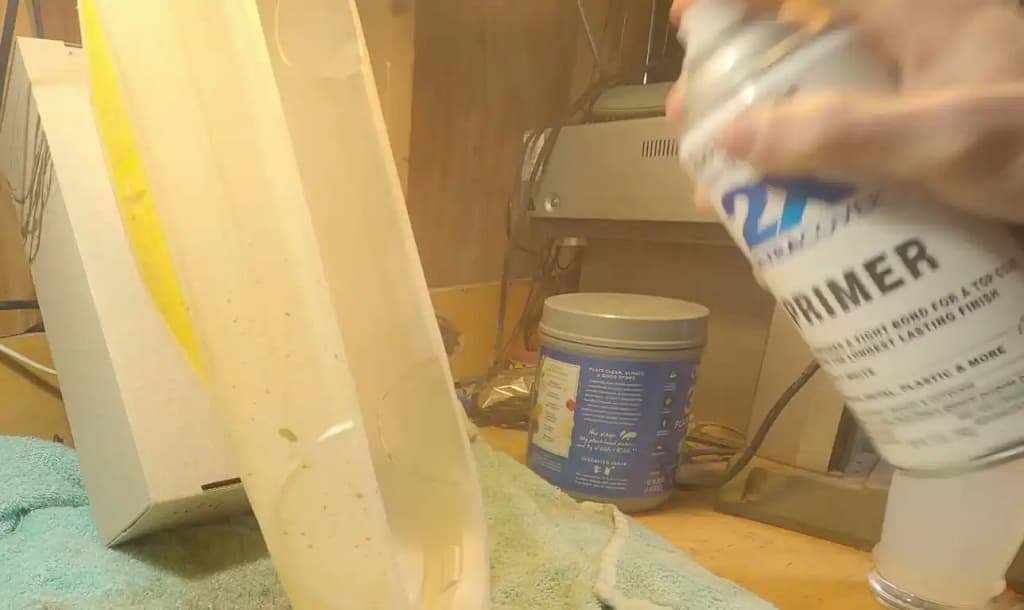 White primer being sprayed over the gold paint on a custom Tamiya TT-02 Celica ST165 body