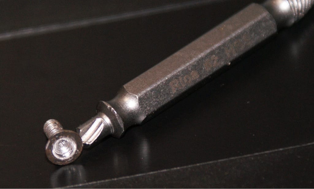 a small striped screw with a #2 extractor bit.