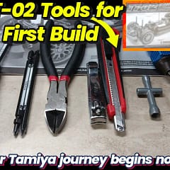 A close-up shot of various essential tools like JIS screwdrivers, nippers, and hex drivers neatly organized next to a Tamiya TT-02 RC car kit, ready for a beginner's first build.