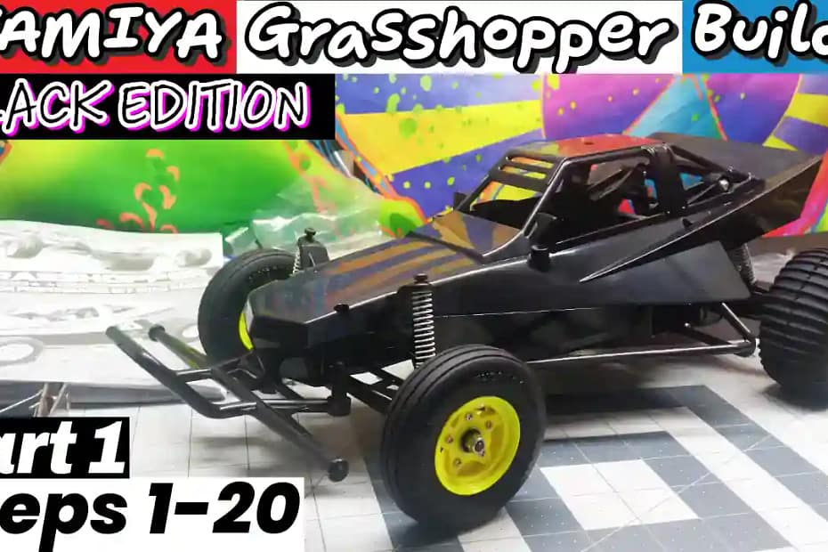 Tamiya Grasshopper Black Edition RC buggy chassis after steps 1-20 assembly, unpainted black body, on the work bench